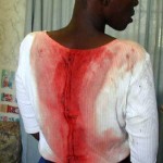 Report Cover Photo: Woman beaten by police during peaceful demonstration called by ZCTU on 18 November 2003: Bulawayo. Report Cover Photo: Woman beaten by police during peaceful demonstration called by ZCTU on 18 November 2003: Bulawayo.