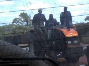 Report Cover Photo: Soldiers driving a tractor