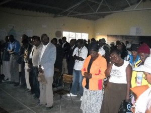 People in rural Matabeleland pray before a COPAC meeting