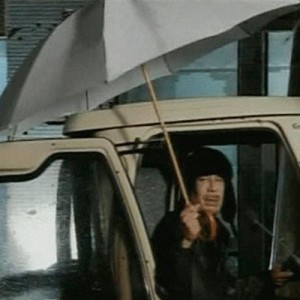 Gaddafi appears on Libyan state television clutching an umbrella